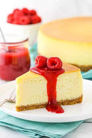A slice of cheesecake with raspberry sauce